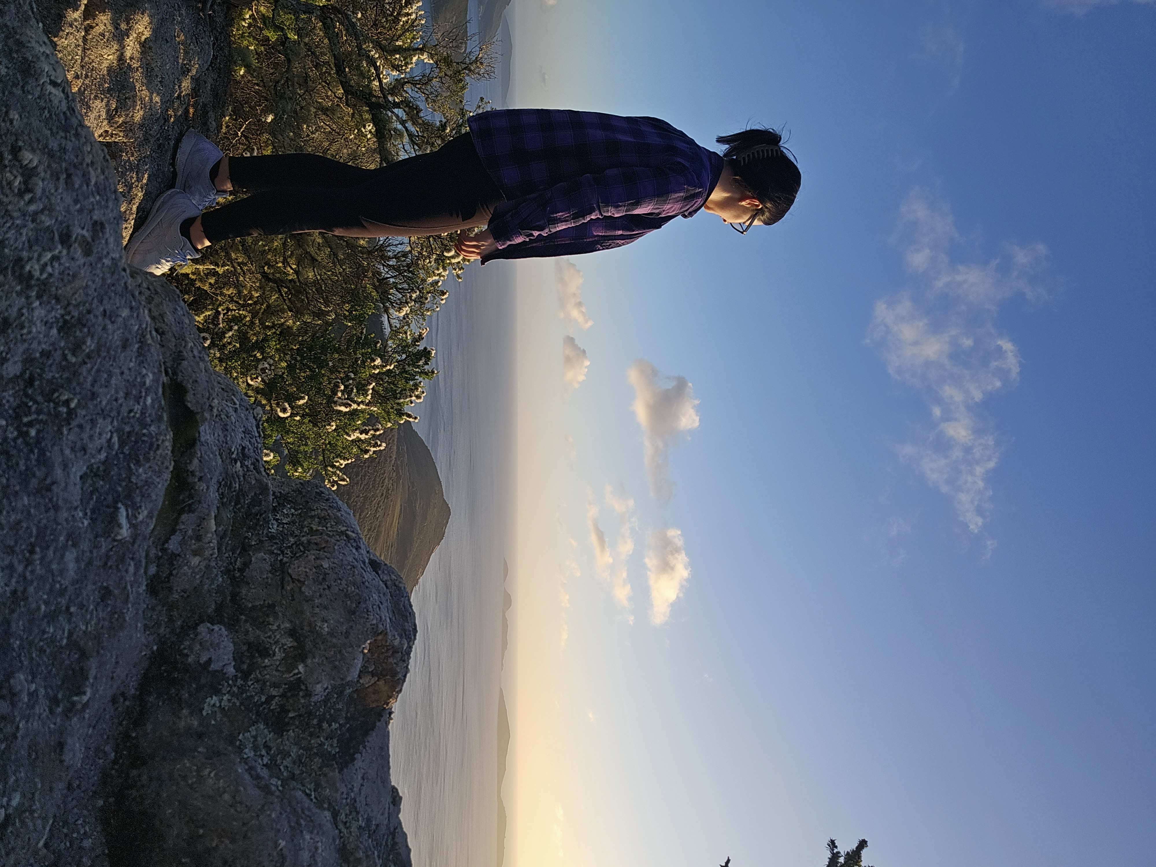 Courtney overlooking the ocean from mountain summit